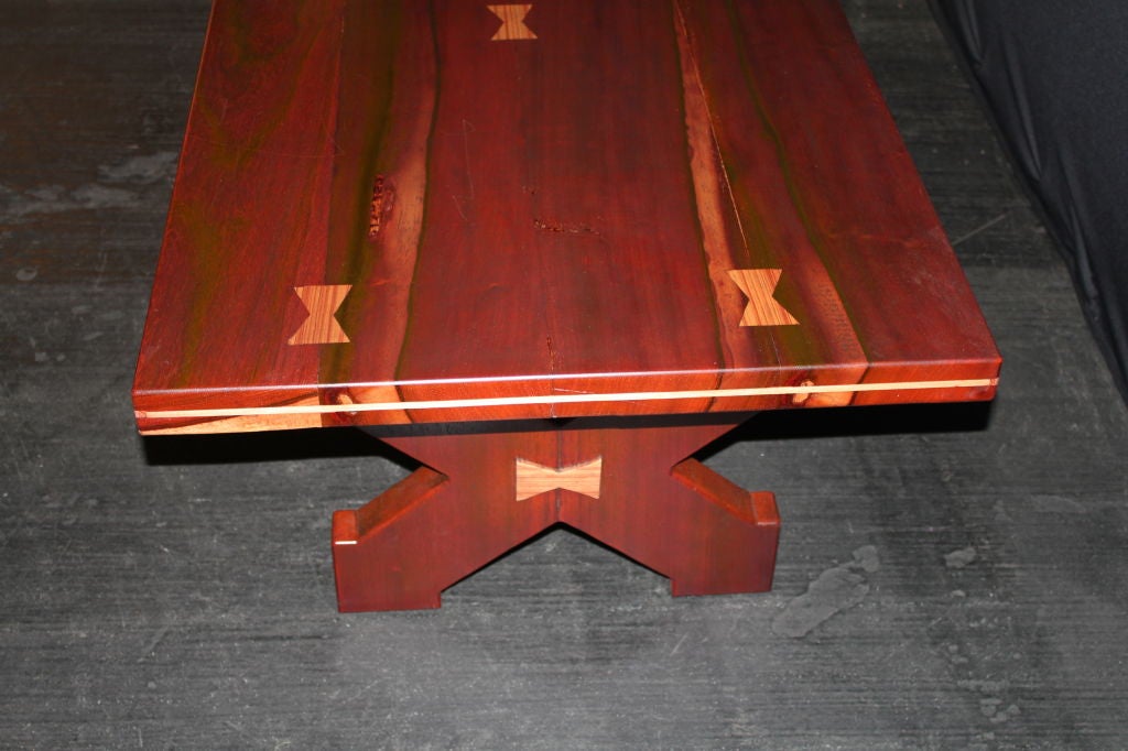 A great craftsman's table made of exotic woods with butterfly details. The wood I believe is padauk, a reddish wood and the butterflies are made of zebrawood. The table is lovely.
