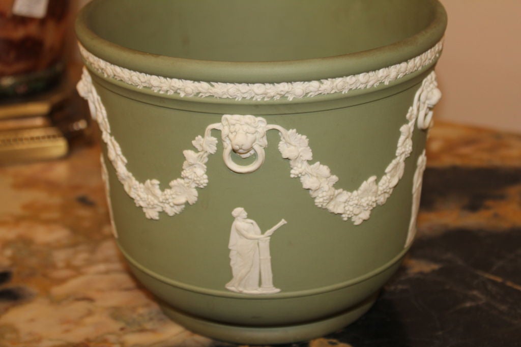 A nice neo-classical themed piece of green jasperware from Wedgwood. Based on the estate we purchased it out of, we date in the to the 1920's. Nice color.