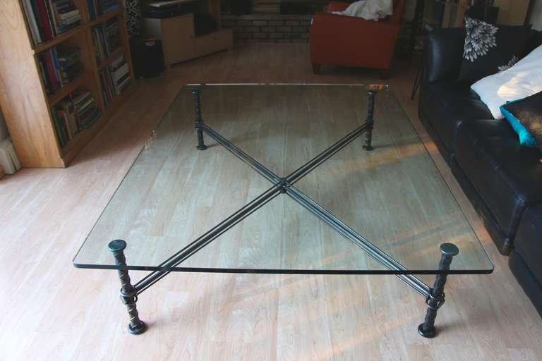 A rather large Ilana Goor coffee table with her typical rebar type construction. This table is quite elegant in it's simplicity without her usual bird adornments. The glass is quite large and heavy. a substantial table. Has a plaque with Goor on one