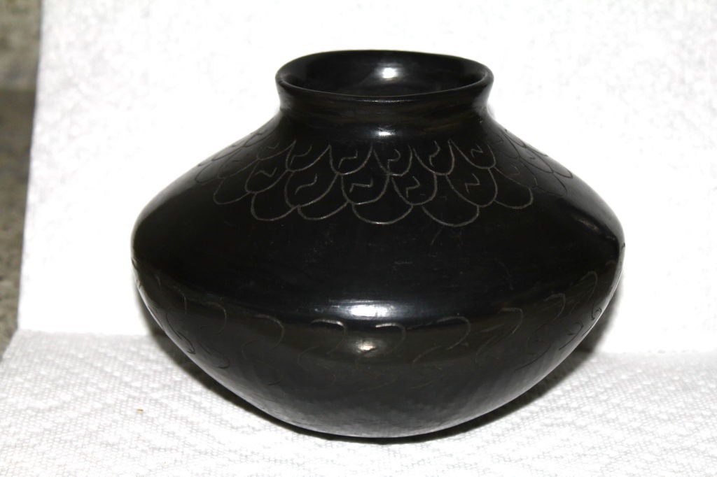 A nice Mata Ortiz black on black incised pot signed manuel Corona NM. It is out of the same estate as the Baleen basket we have posted on the site this week. The woman was a wealthy socialite who traveled the work and donated her time and money to