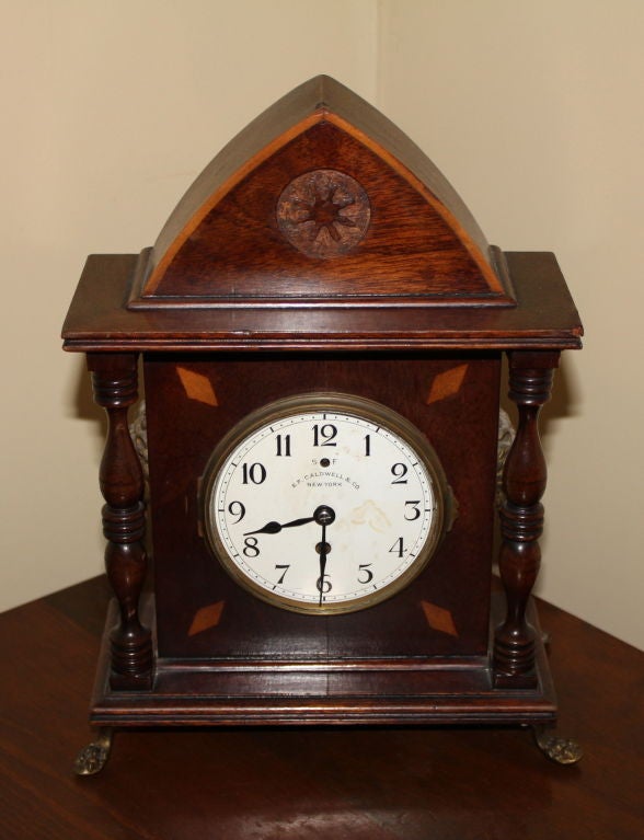 A very nice late 19th century clock produced for the prestigious E.F. Caldwell Retailer by the high end Clock make Chelsea co. of Boston. This clock is mounted in a very decorative case with paw feet and brass lions on the side. This clock is