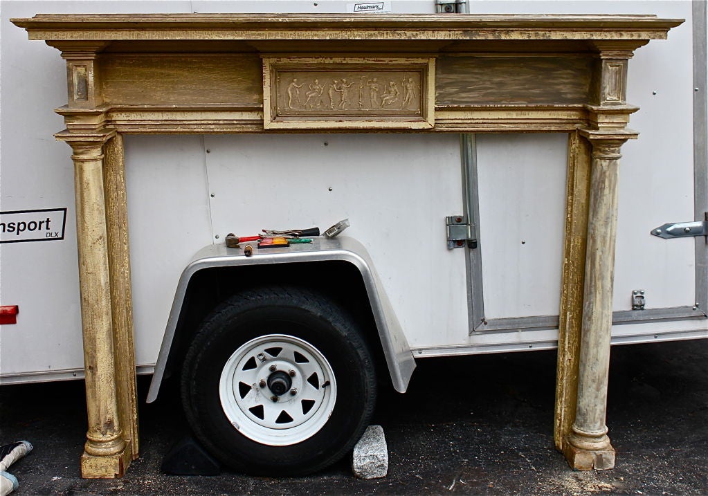 19th century mantel with a neoclassical motif