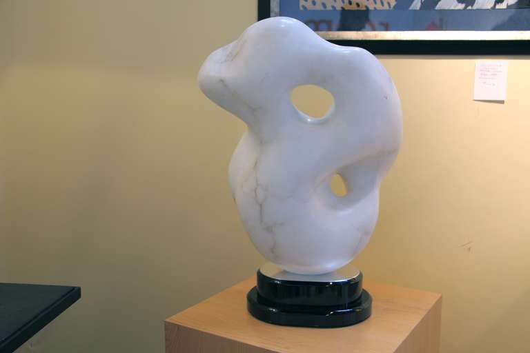An extremely cleverly done white carrera marble sculpture by Stephanie Klein mounted on a ball bearing base which allows the sculpture to rotate easily. The attribution is from the estate who purchased it as this artist. The veining on the marble is