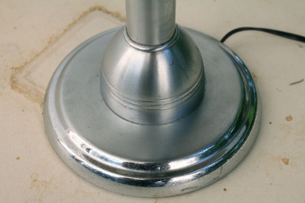 A rare and unusual lamp with three sockets and a fan mounted on top. I believe there were called lamp-o-fans or fan-o-lamps.  It has a great chromed metal top with a painted interior that is not original. It has been re-wired and new felt put on the