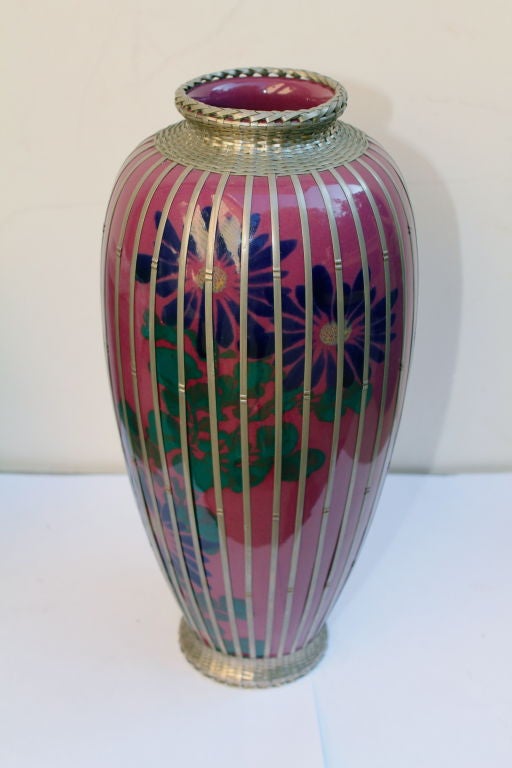 A very pretty Japanese hand painted pottery vase with a basket weave pattern silver-plate overlay.