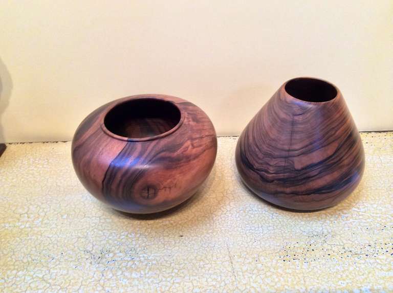 2 elegant wood turned vessels by the noted craftsman Gene Pozzesi. They are both signed and one is identified as ebony, the other Macassar Ebony. The smaller one is 4 inches tall and 5 inches in diameter. The larger one's dimensions are 5 inches