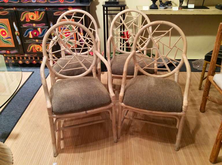 A set of 4 cracked ice chairs in a whitewash finish that is in the style of McQuire's chairs. These rattan chairs match a table we have also listed. The fabric is very nice and clean.