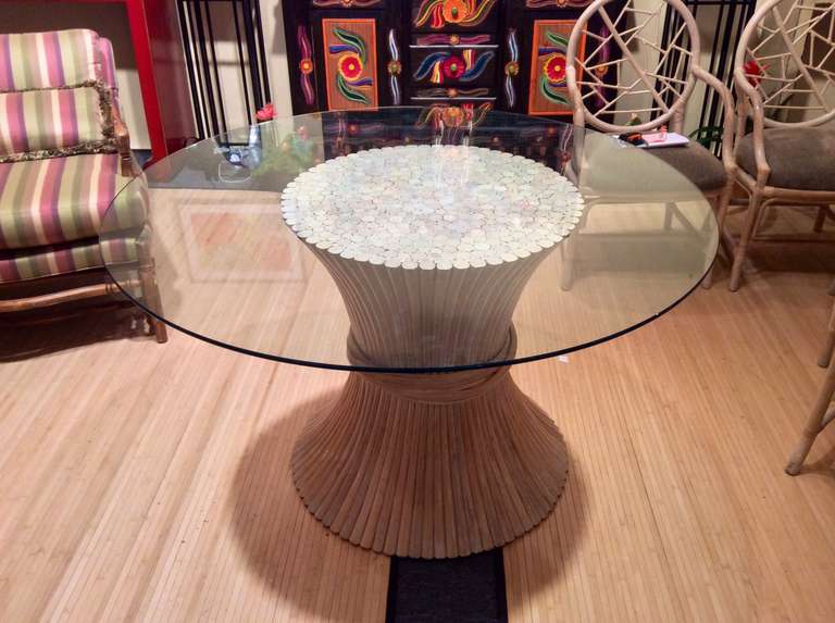 A nice dining table in the manner of a Mcquire design sheaf of wheat table base. This is a lovely base that may be shipped with or without the 48 inch round table top. It will hold a larger top if desired. It is priced with the glass. 
This has a