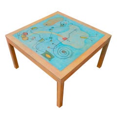 Whimsical faux painted table with a miro like painting on top.