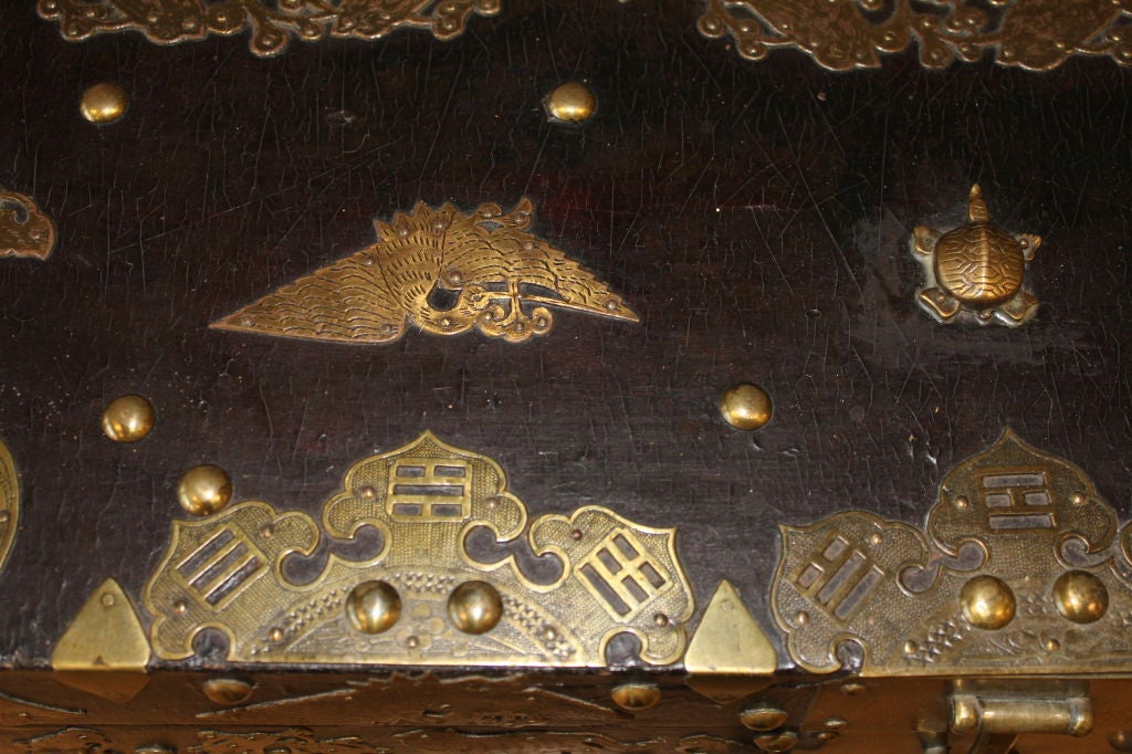 Anglo Southeast Asian Brass decorated lacquer chest on stand