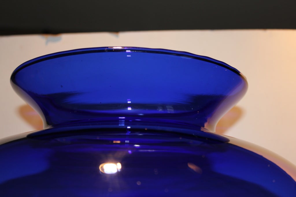 A very large pair of hand blown cobalt blue vases. One has an unusual 