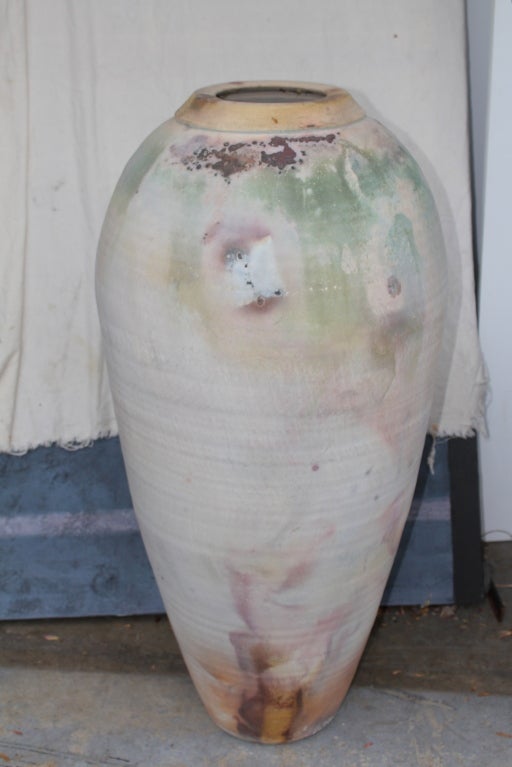 An incredibly impressive floor vase in a raku fired glaze that stands almost 40 inches tall. Nice color and glaze. Signed on the base what looks like M. Swenson.