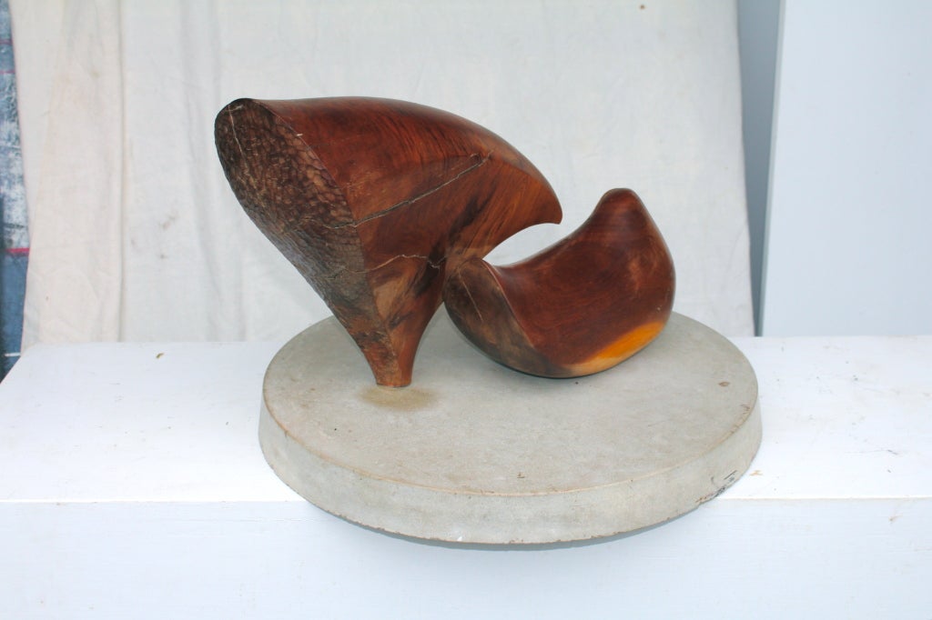 Carved wood abstract figures on a stone base