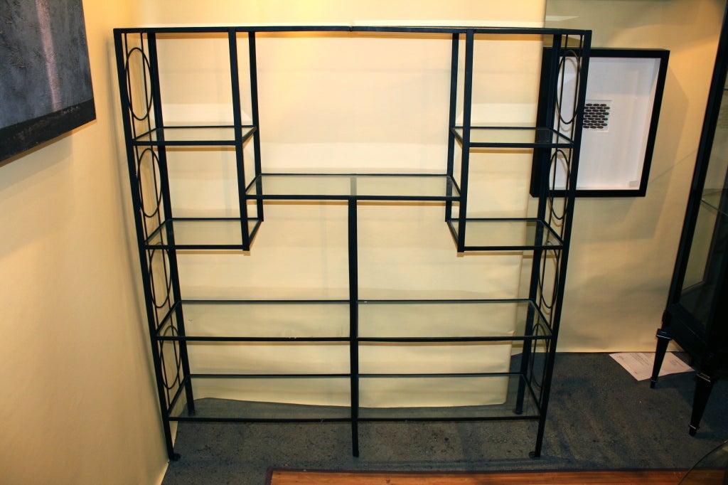 A great looking iron and glass etagere. It features 5 long shelves and 4 small ones. Nicely designed by Frederick Weinberg.
