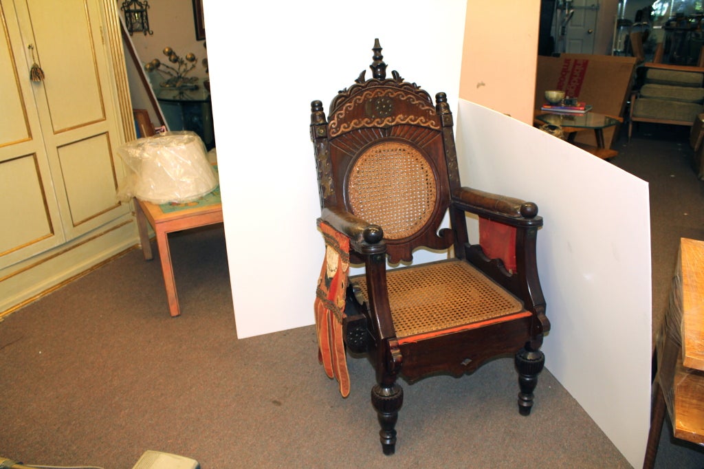 An unusual Throne definitely from Africa but probably Colonial and most likely Anglo-African. It was probably made for a governor or Colonial Administrator. It features brass appliques and some uniquely decorated fabric sides. It also probably had a