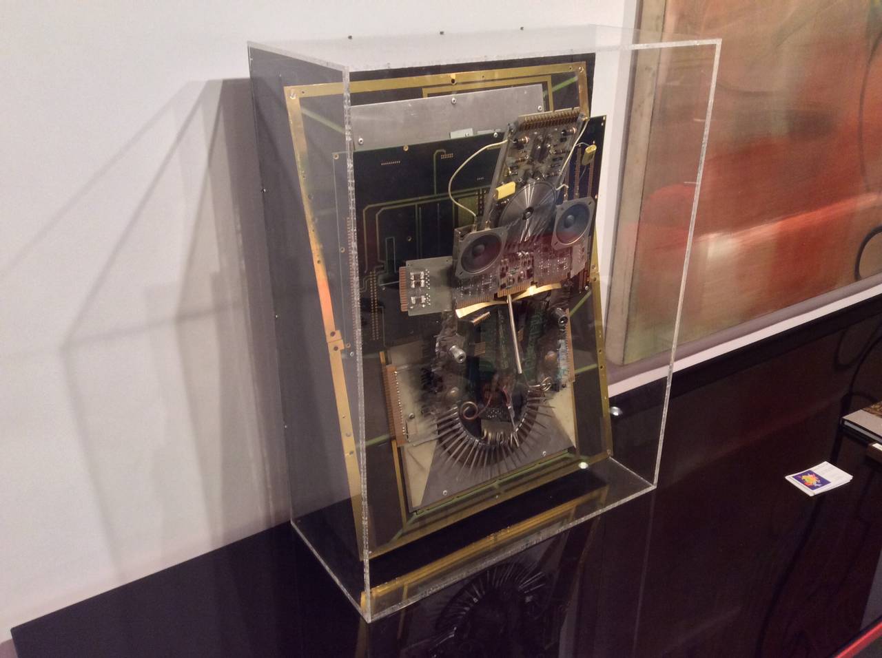 A signed rather unique wall sculpture comprised of old computer chips and equipment. It is housed in a Lucite frame. It is dated 1988.
There are some missing pieces, although we are unable to definitely tell where. The lucite edges have crackling