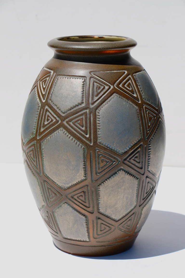 A nice metallic glazed vase designed by Joseph Mougin in an Art Deco geometric pattern. Signed and numbered on the base. 