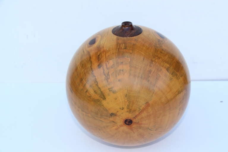 A quite beautiful hand-turned vessel by the noted artist John Mascoll. It is carved out of Norfolk Island Pine. Signed on the base.