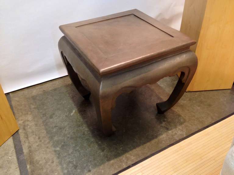 An incredibly heavy bronze table in the Asian Style. It must weigh over two hundred pounds. It is very elegant in design and form.
