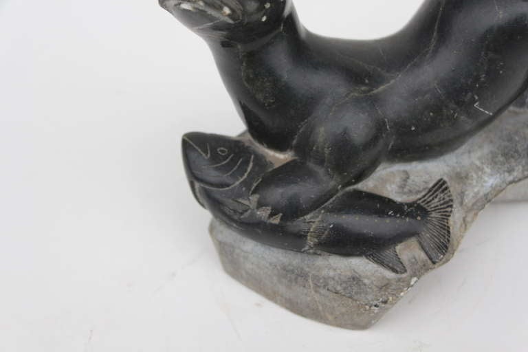 Unknown Older inuit sculpture of seal or walrus catching a fish