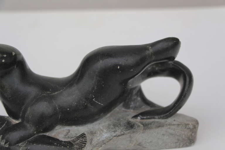 Older inuit sculpture of seal or walrus catching a fish In Good Condition In Palm Springs, CA