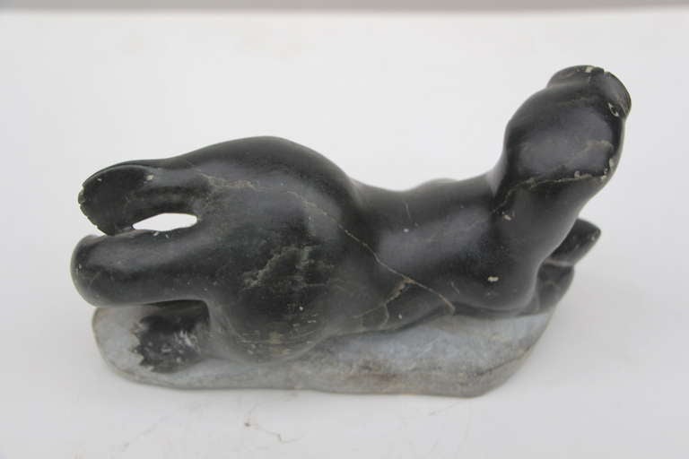 20th Century Older inuit sculpture of seal or walrus catching a fish