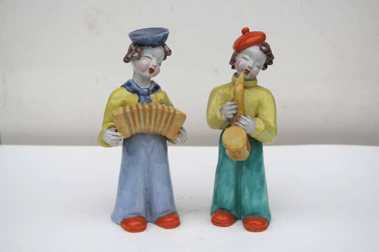 A wonderful pair of ceramic or glazed terracotta figures by the noted Hungarian born artist Maria Rahmer. They feature an accordion player and a saxophonist. One is signed and the other is monogrammed on the base.