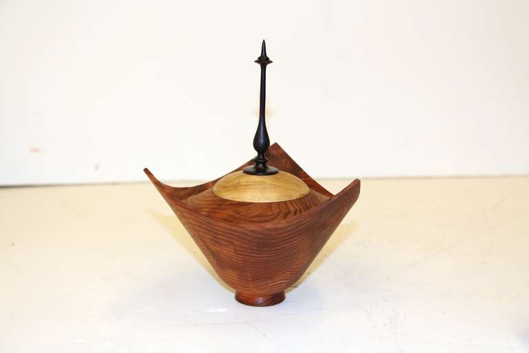 A beautifully turned vessel with a lid by the noted Northern California woodworker Paul Maurer. This most unusual piece is signed on the base.
Paul is noted for only using fallen and found wood.