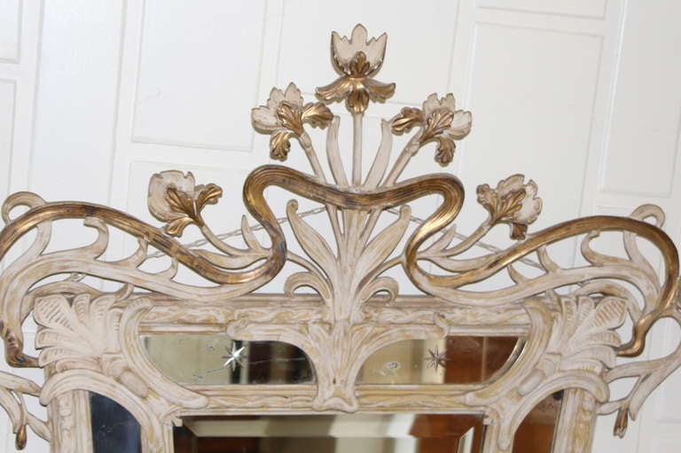 A nice art nouveau mirror with etched stars in the side panels. Nicely carved wood with some remaining original gilt.