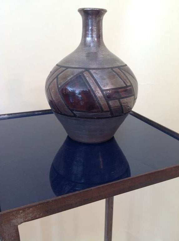 A quite beautiful pice of pottery in a raku glaze by the noted pottery team of  Claudette and Paul Gerhold. This piece features a geometric design. It is monogrammed on the base.