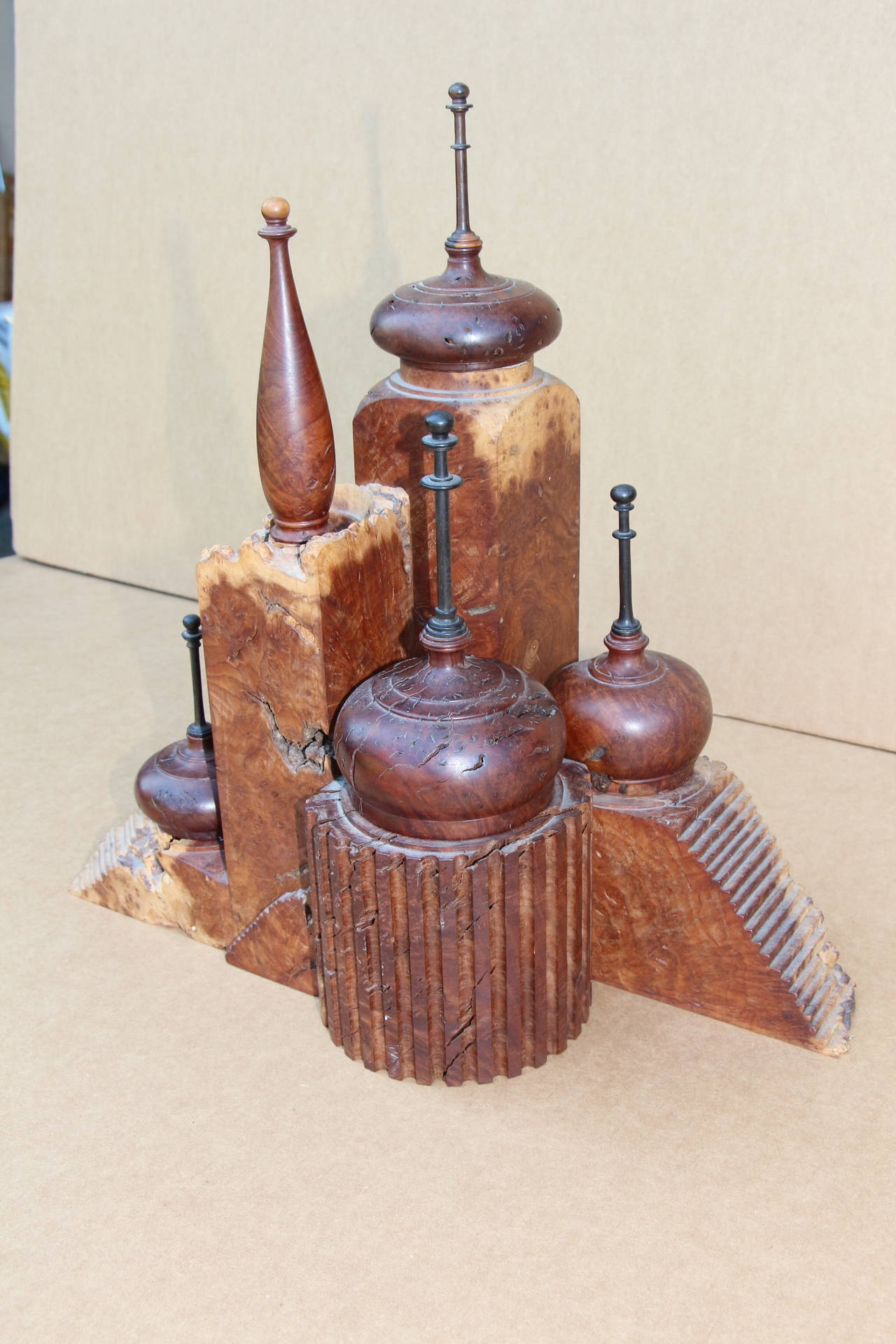 A most unusual burl wood hand-turned desk top item built to look like a castle with stairs and turrets. There is a letter opener in one made of Macassar ebony for the blade. The tops are removable and there are is some dabs of wax or some other