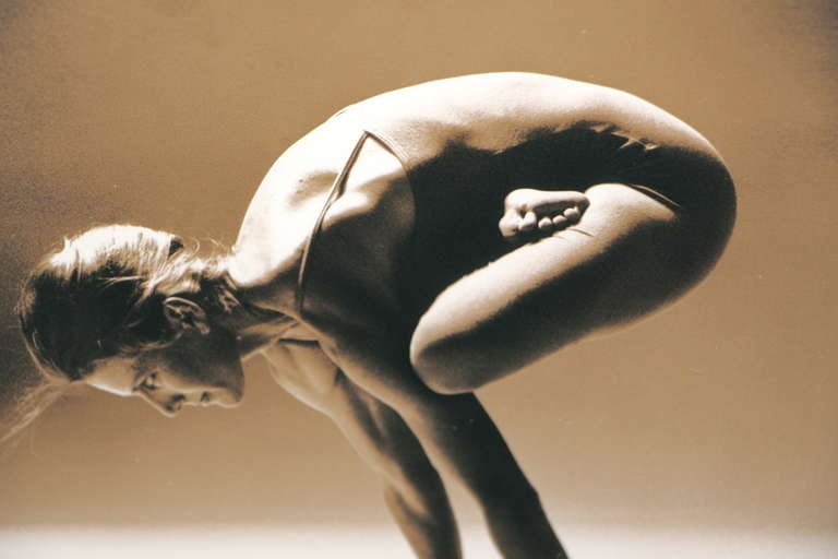 A nice sepia toned silver gelatin photograph of a woman in a yoga position. From a nice collection of photographs that date to the 1970s. Unknown photographer.