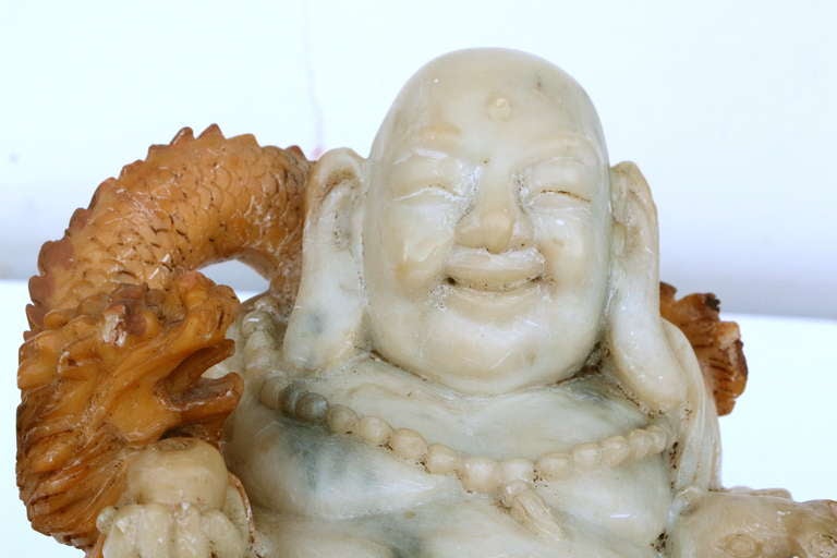 Unknown Asian carving of a smiling Buddha with cat and dragon
