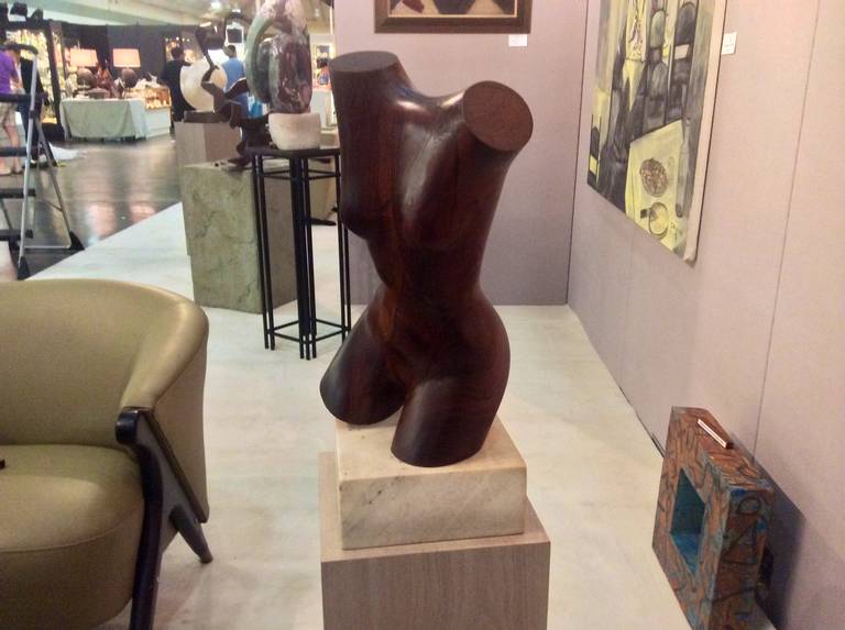 A quite lovely nude torso of a woman on a marble base. It is by william slidar and is elegantly carved out of an exotic dark wood.