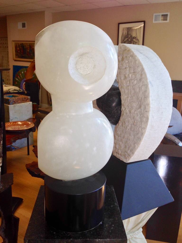 A wonderful and whimsical alabaster sculpture on a round base. Nice veining and beautifully carved.