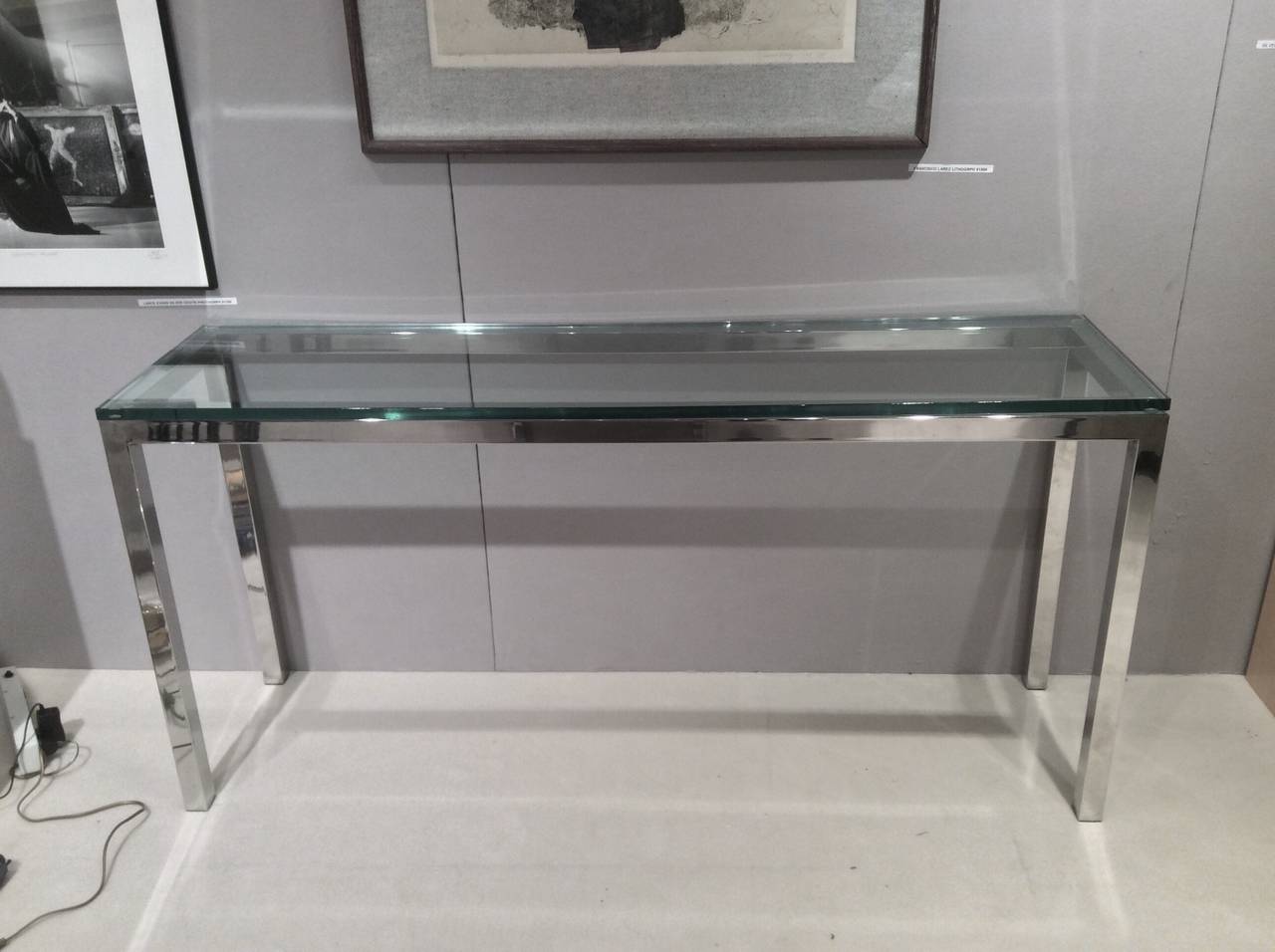 A nice chromed steel and thick glass top console table.