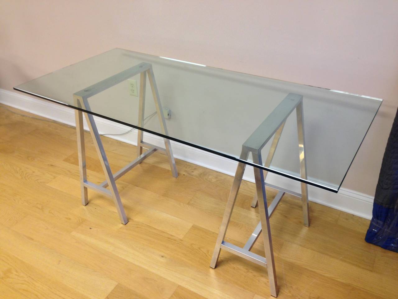 A nice glass top table or desk with saw horse aluminum legs. They are high quality with excellent welds. Nice thick glass.