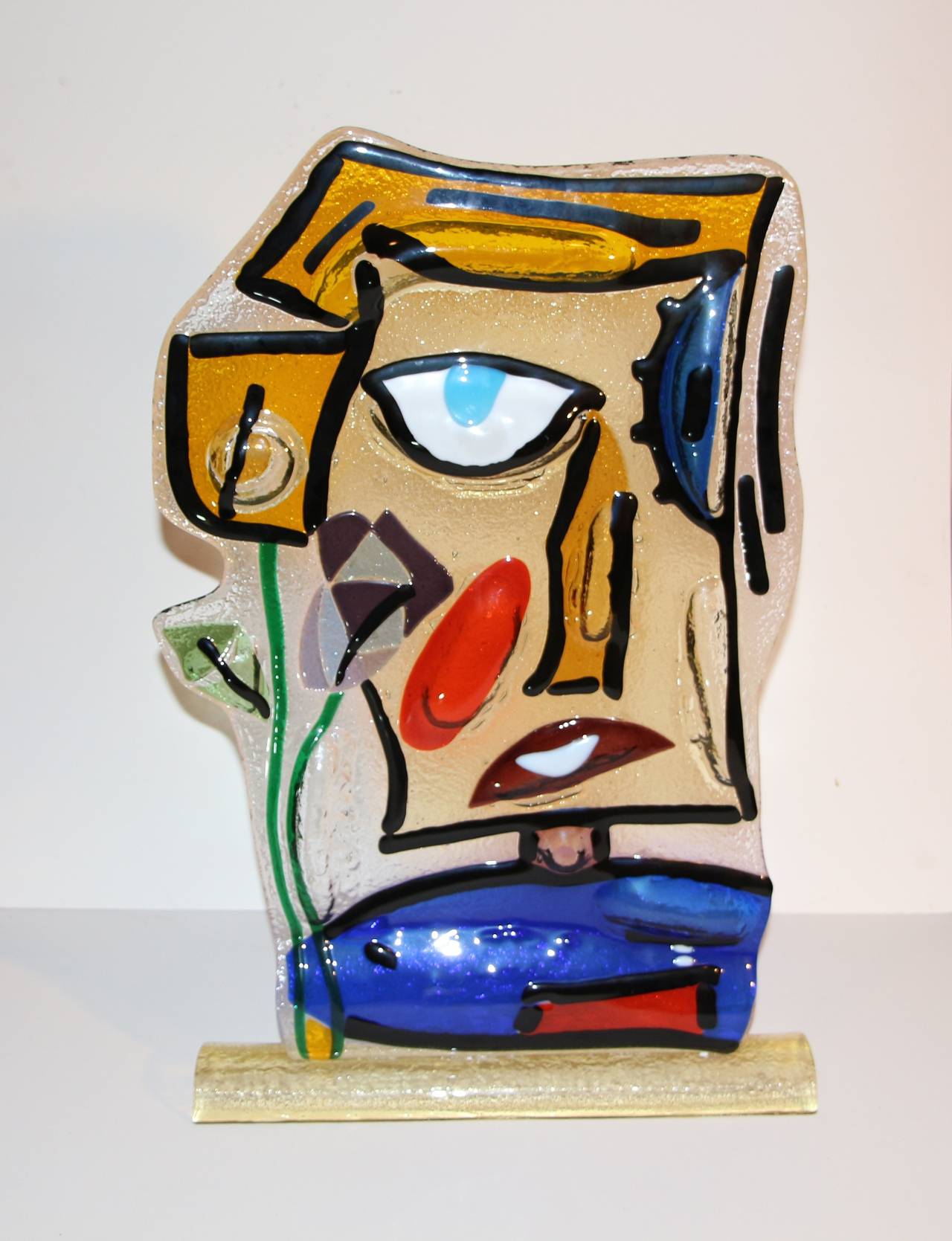 A whimsical large glass handblown face with an etched signature and the name Vercos Murano Italia etched into the base. Nice large sculpture.