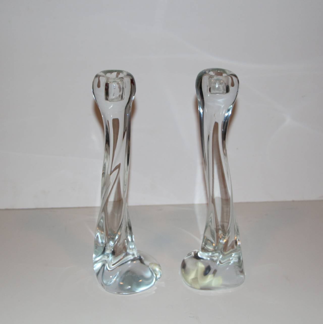 A pretty pair of organic handblown Italian Murano candlesticks with the original labels. According to a few Murano label websites this label is found on a signed sculpture of embracing lovers. Known to be from a company founded by Renato Anatra and