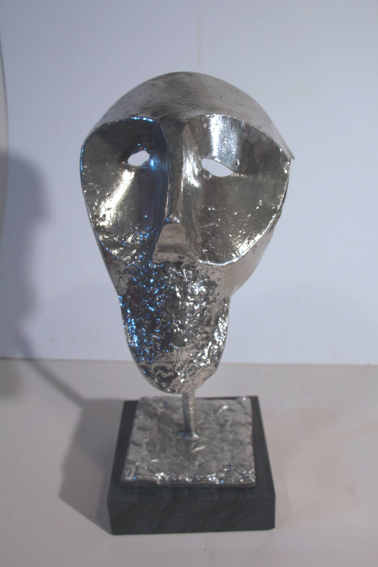 An unusual and intriguing case heavy metal bust mounted on a marble base. Well executed but no apparent signature.