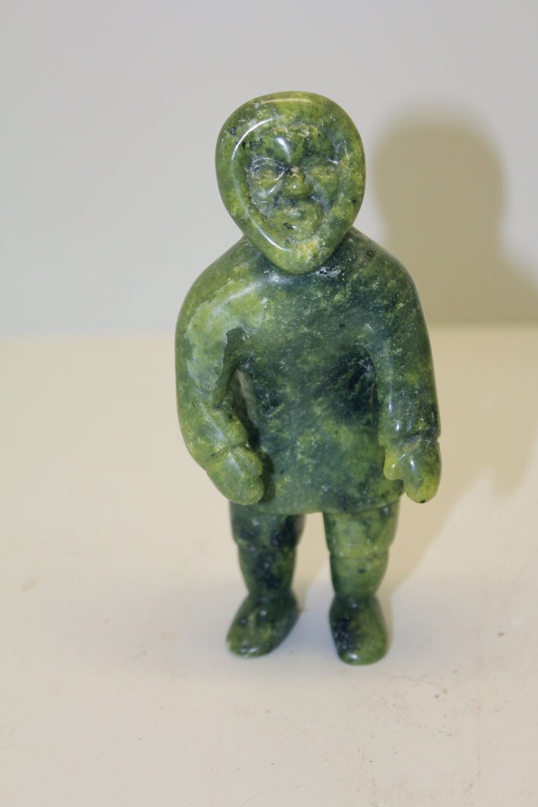 An Inuit carving of a man signed on the base. Great Color. It  appears to be a soapstone carving. Great color and striations.The man is approx 4.5 inches tall and approx 1x2.5 inches in dimension. It is signed on the base. Age appropriate wear with