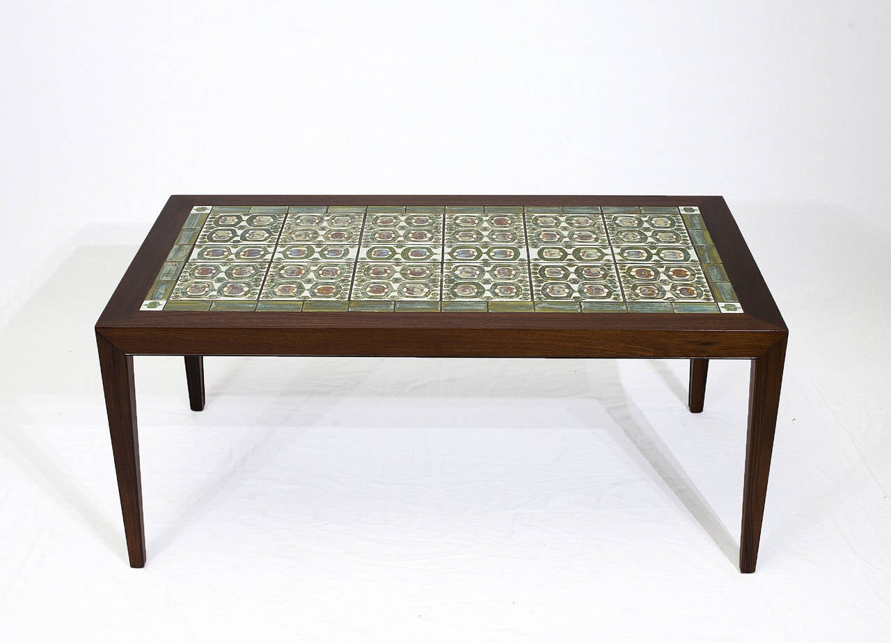 Rosewood coffee table with Royal Copenhagen tiles by Nils Thorsson. 
Designed by Severin Hansen Jr. and produced by Haslev Mobelfabrik.  Store formerly known as ARTFUL DODGER INC