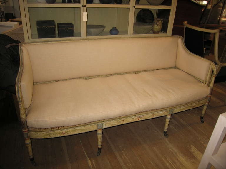 an intricately painted Adams style settee with new linen cushion and uphostery over a caned seat