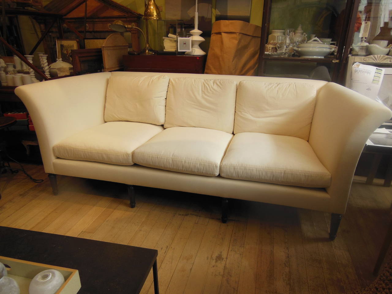 Elegant vintage sofa totally redone in muslin on fluted legs.