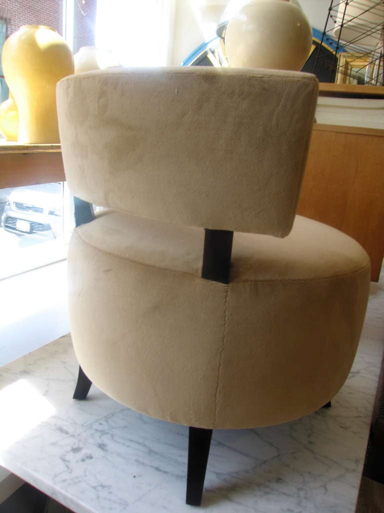 a small upholstered chair newly done in mohair velvet on dark legs
