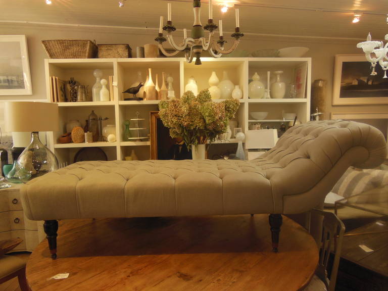 a beautiful tufted chaise newly redone in grey linen