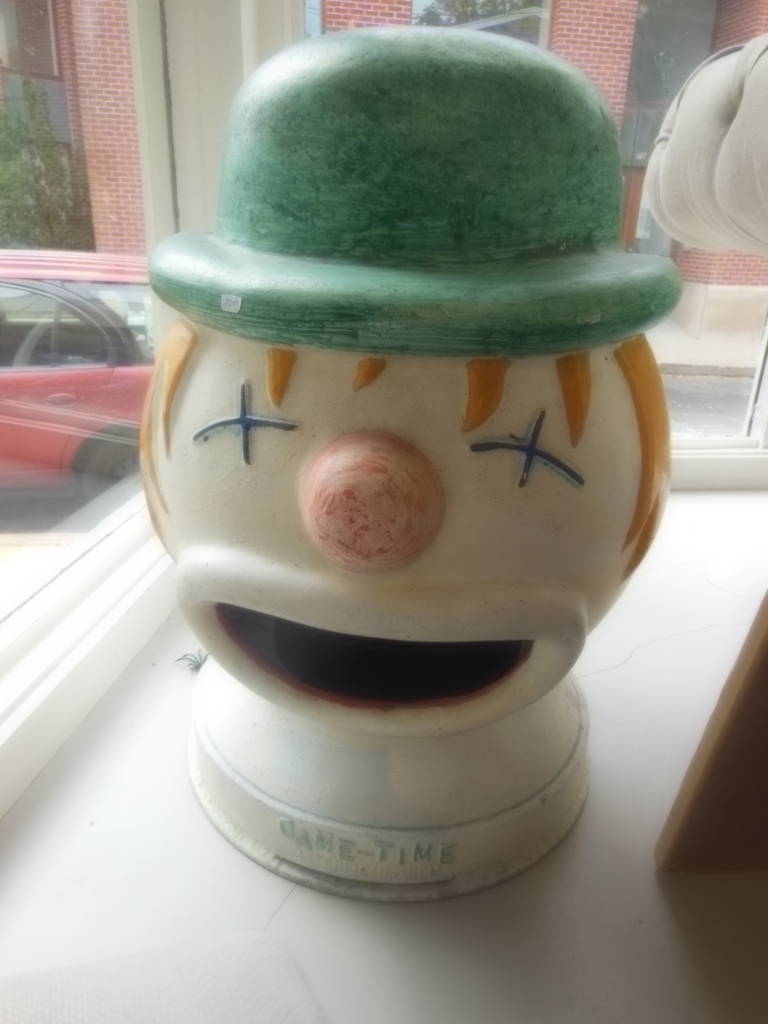 a painted metal carnival game clown head