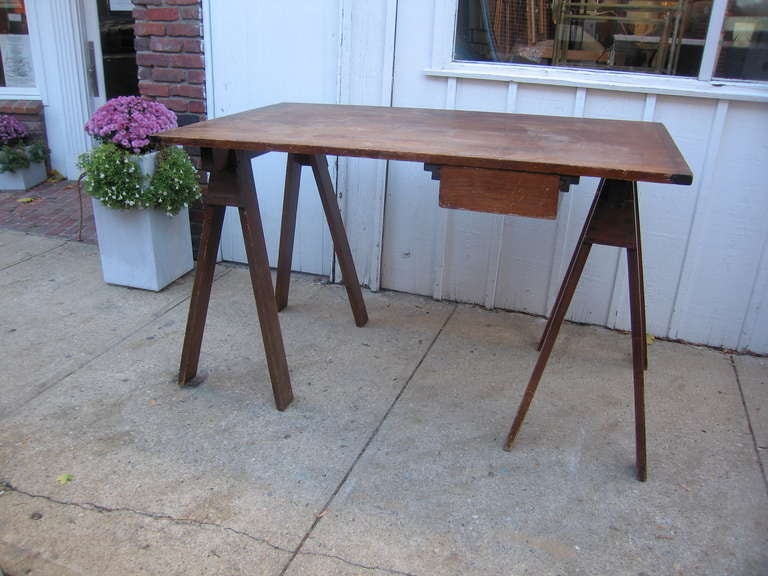 simple vintage table top on trestles with drawer