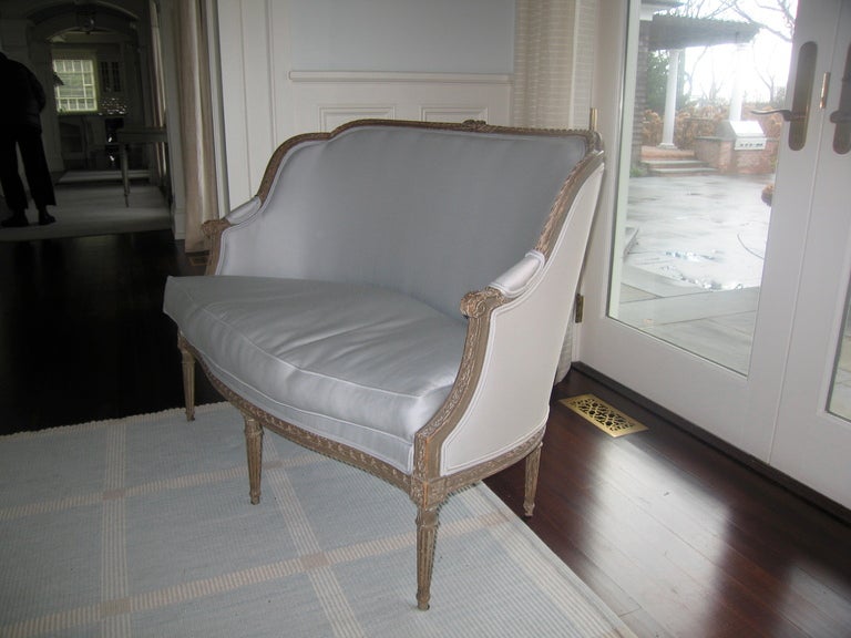 very nice French settee newly upholstered in blue silk , nice payina on painted, gilt carved frame