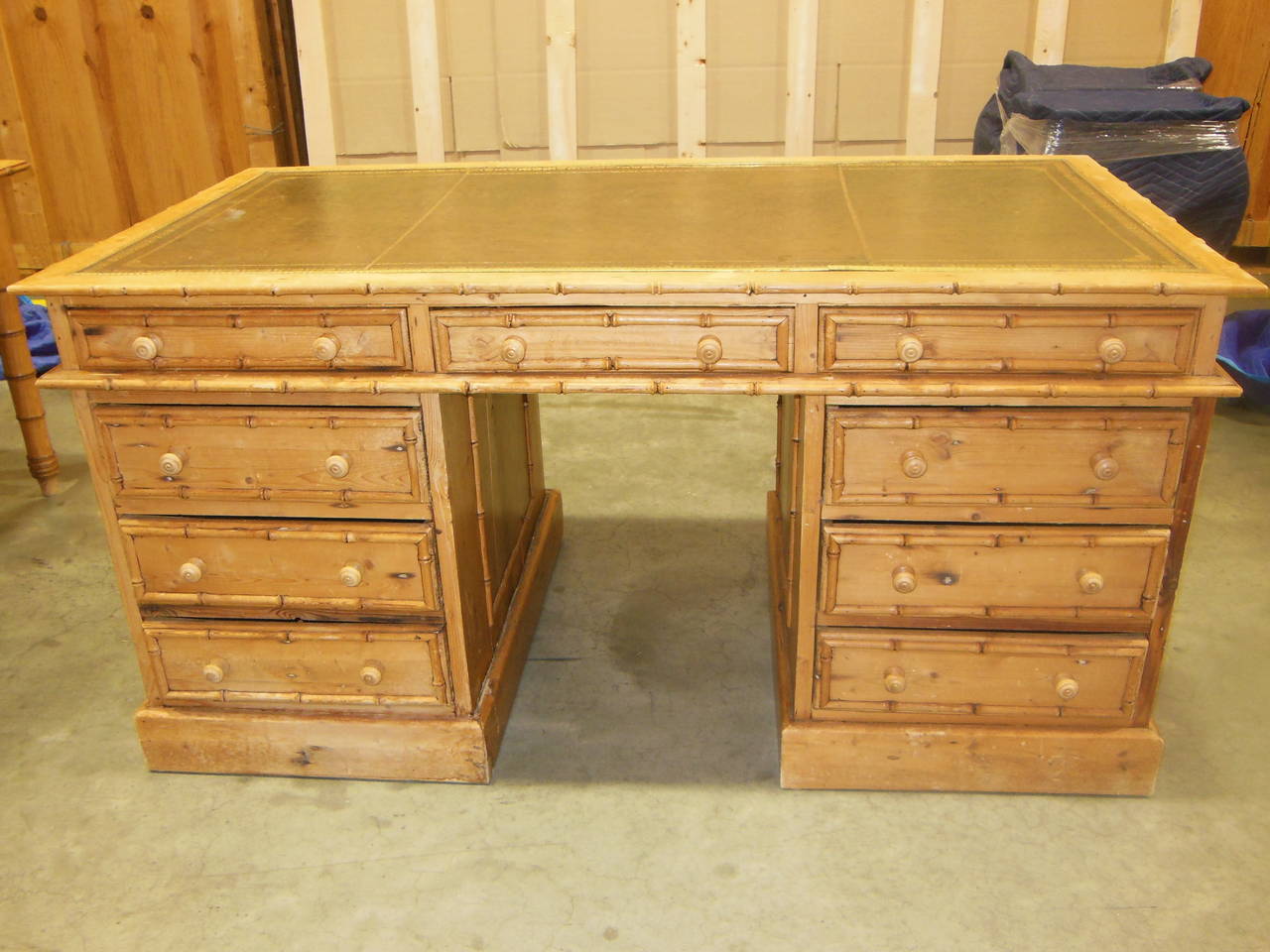Very handsome faux bamboo desk finished on both sides with a scrolled leather top and brass trim.